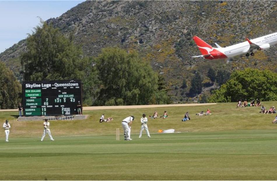 A plane halts play as it takes off from Queenstown Airport.