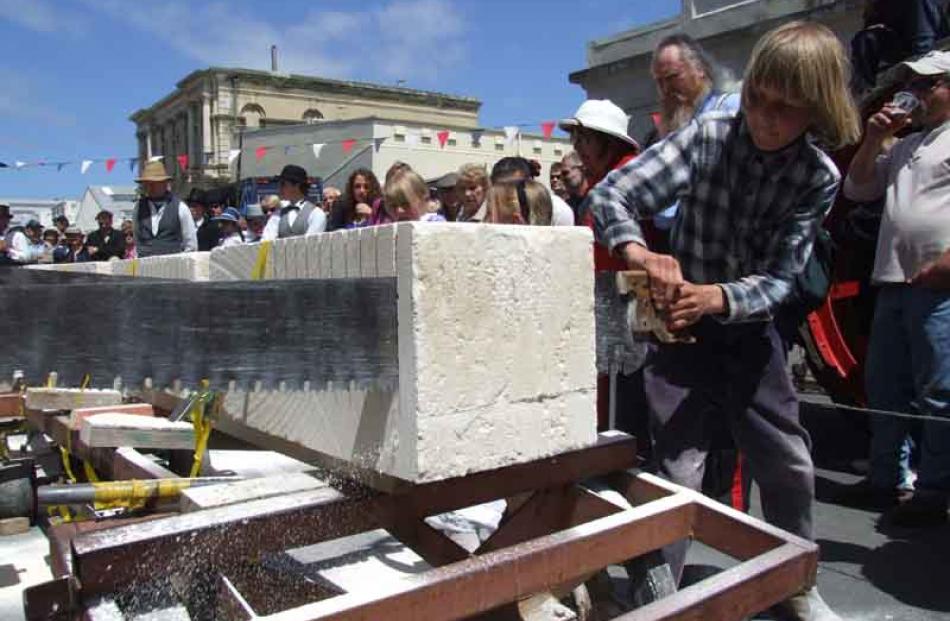 Dust flies . . . Daniel Vinbrux (12), of Oamaru, competes in the stone-sawing competition at the...