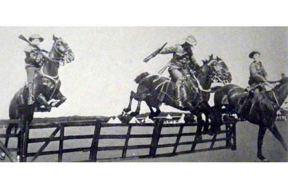 Otago Hussars take their mounts over a hurdle during the annual sports at Tahuna Park on Saturday...