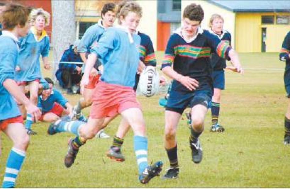 Stop right there: Southern’s Sam Mosley is about to kick the ball, with Central’s Hamish McMillan...