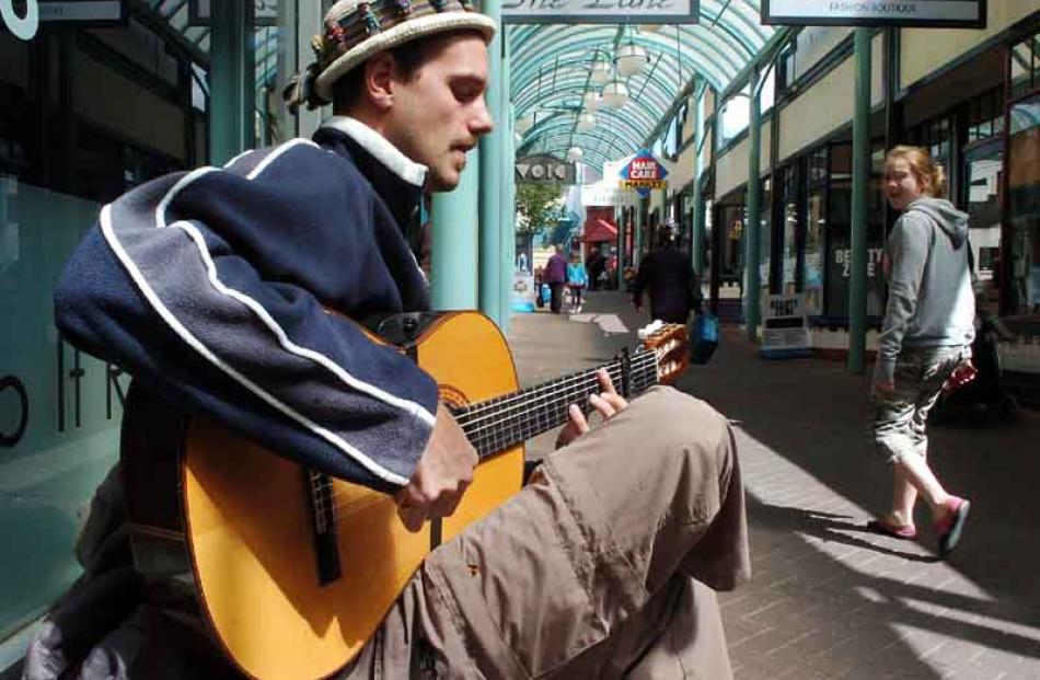 Aram Spruit, of Spain, busks in Albion Ln to help fund his travels through New Zealand.