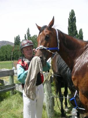 Mick Prendergast, of Hyde, attends to Manchester Tom after competing in a race.