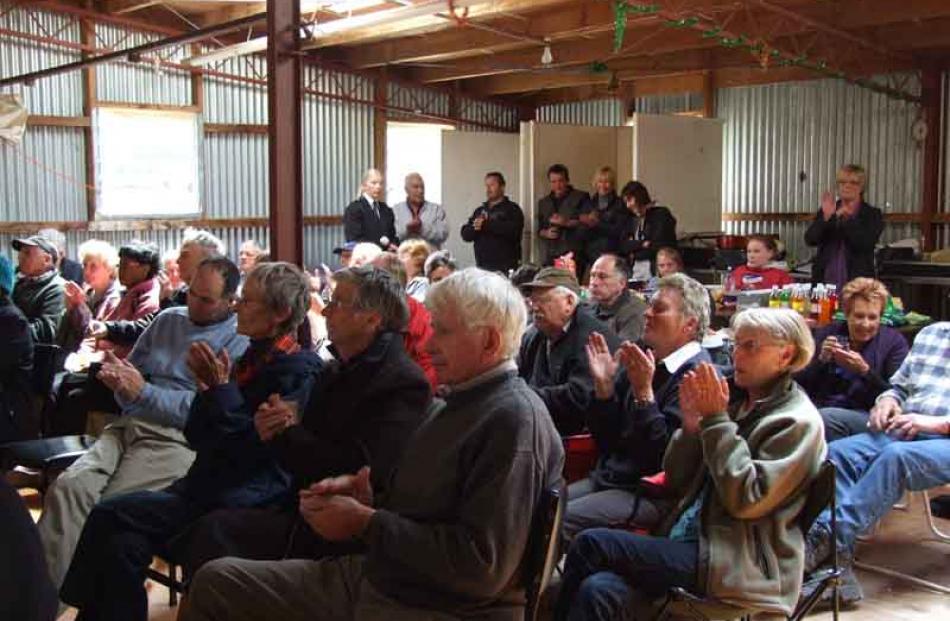 A crowd of about 80 people soak up the shearing shed ambience.