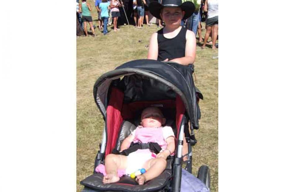 Jed Comber (7) takes his younger brother Bryan (11mths) for a walk in his pram at the Wanaka Rodeo.