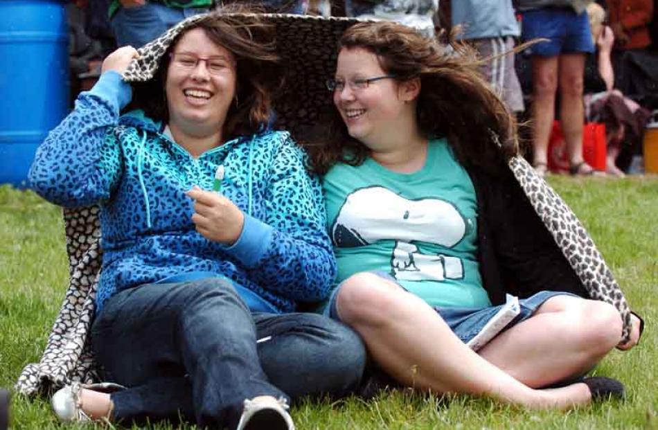Nicole and Amanda Hewitson, of Dacre, shelter from the elements at the Roxburgh Trotting Club's...