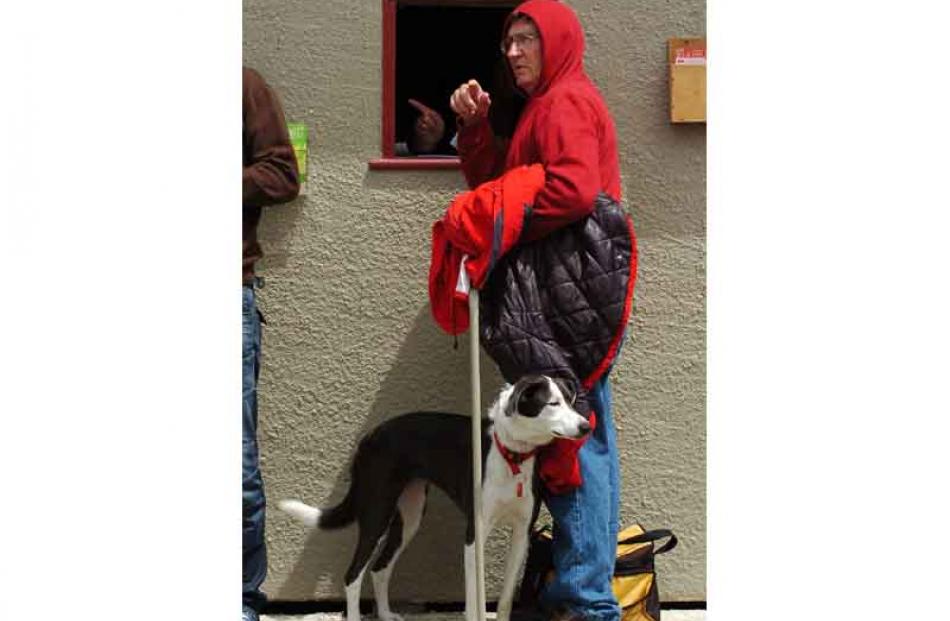 Paul Wallis of Clyde and border collie ' Stella ' place a bet.