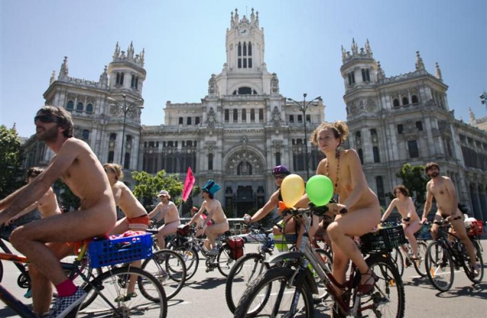 Cyclists ride naked through central Madrid. Photo  by AP.