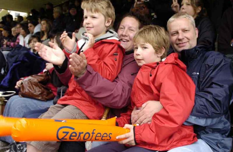 Arrowtown family Tom Happs (9), Clare, Ben (11) and Dave enjoy the action from the covered stand.