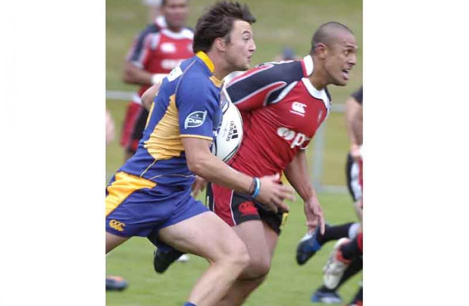 Julius Glasson of Otago with ball and Siaosi Tuatao of Counties Maunkau.