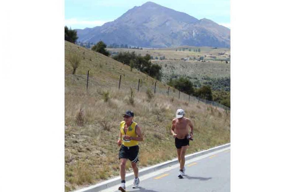 From left, Dunedin's Lindsay Dey leads his fellow 60-69 age group competitor Ralph Gill, also of...