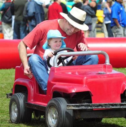Simon and Audrey (2) Edmonds, of Dunedin, drive a mini car.