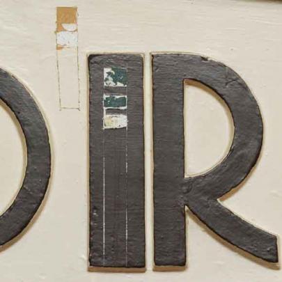 The earlier colours revealed after small patches of paint were removed from plasterwork and signs.