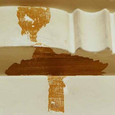 The earlier colours revealed after small patches of paint were removed from plasterwork and signs.