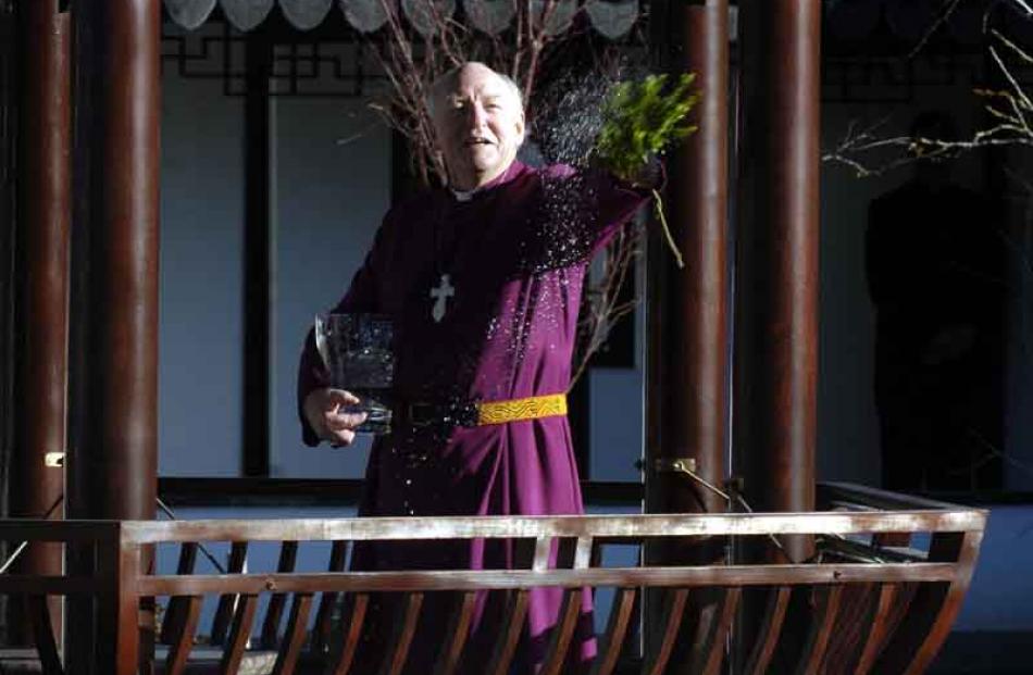 Anglican Bishop of Dunedin George Connor splashes water during a blessing ceremony.