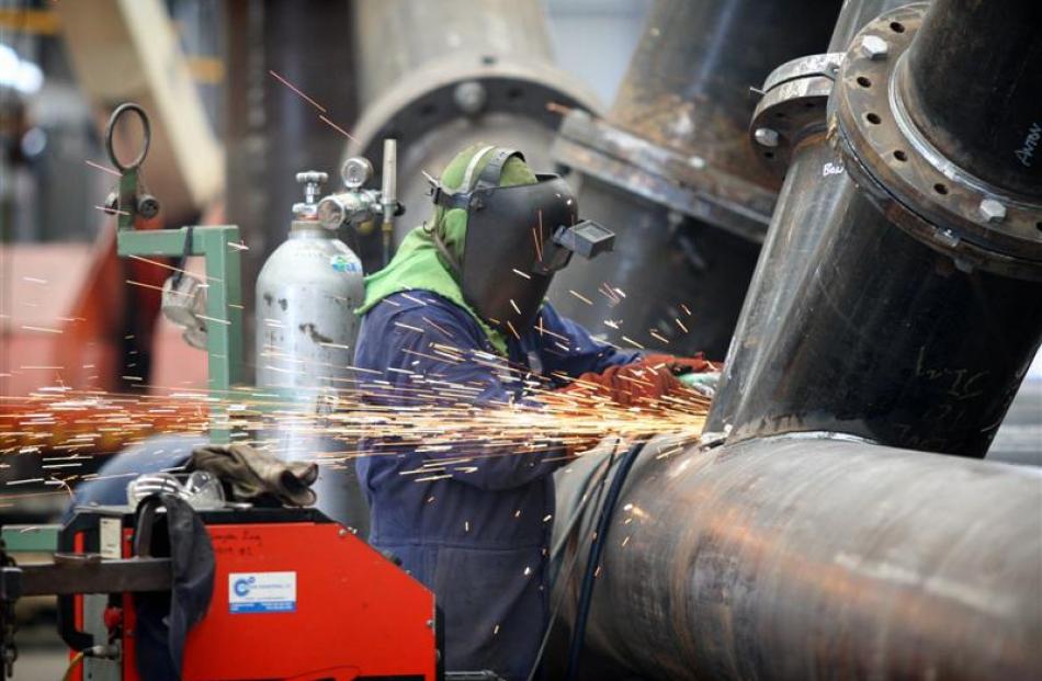A Grayson Engineering worker welds a section of one of the steel columns, which will be partially...