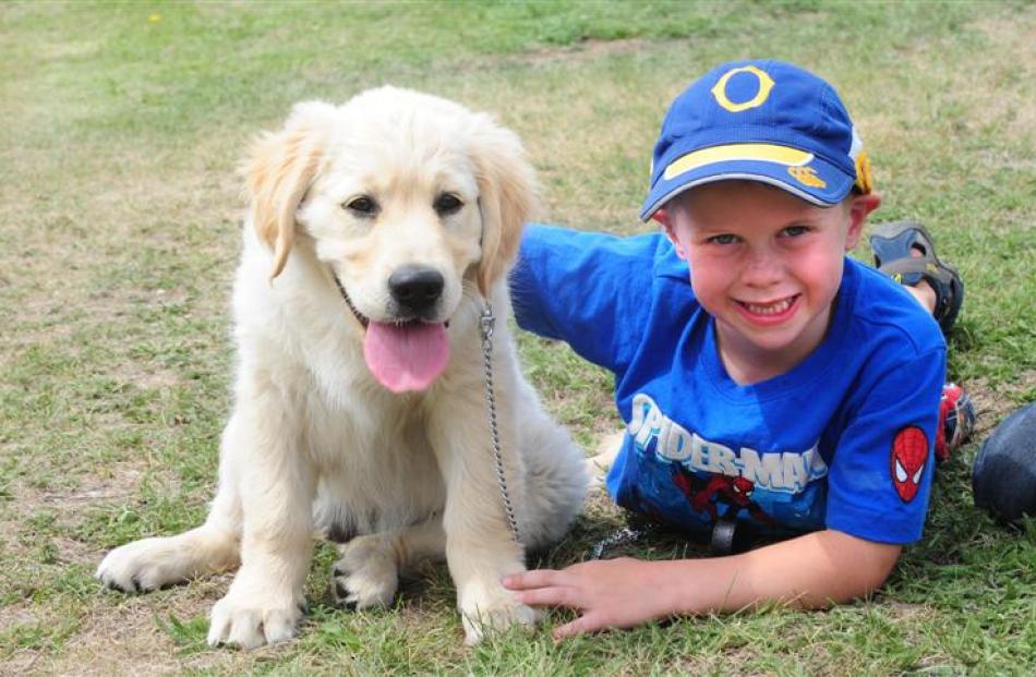 Winner of the pet parade Will Pringle (5), of Ranfurly, pats puppy Muddy Paws.