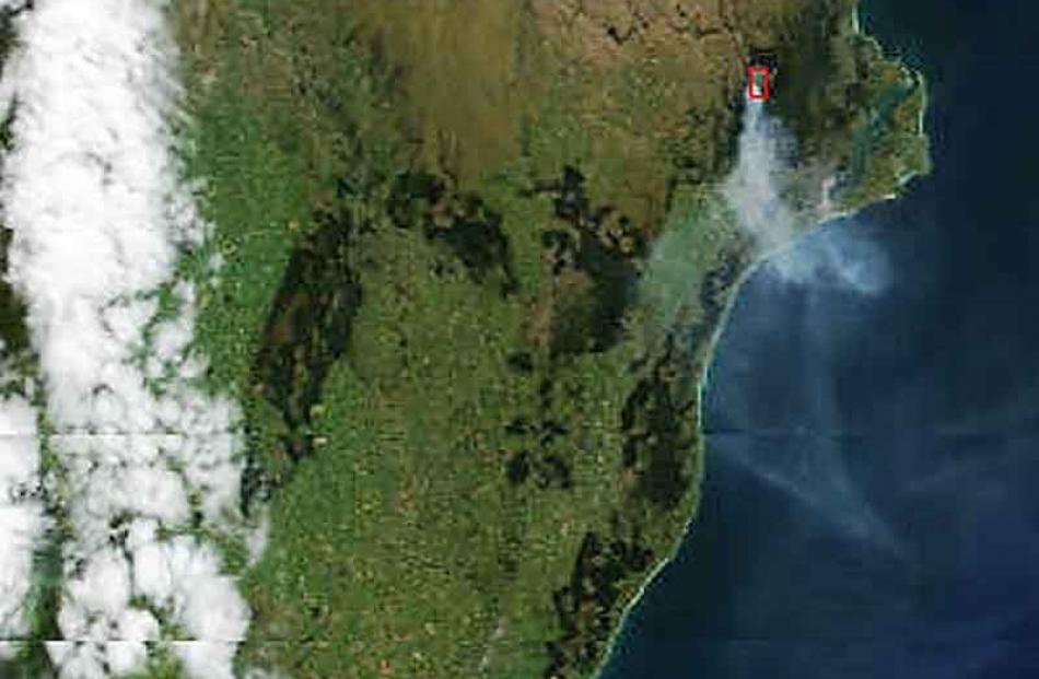 A bank of cloud (left) and the Mt Allan fire (boxed) photographed by the Nasa/GSFC satellite...