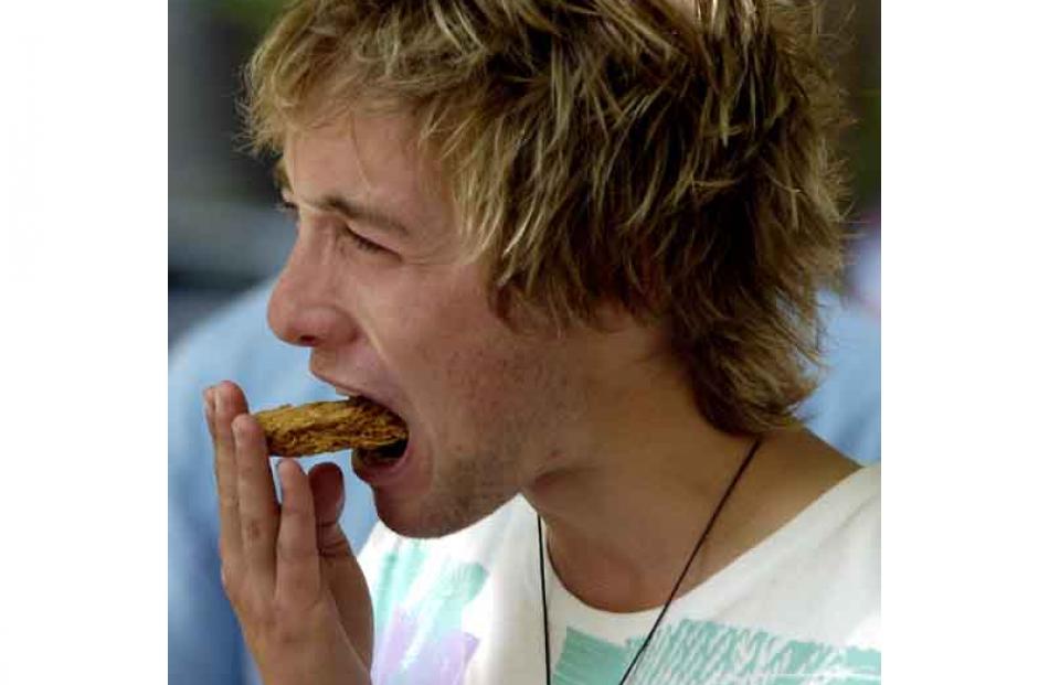 Freshers' extreme challenge: Gus Patterson eats a weetbix. Photo by Jane Dawber.