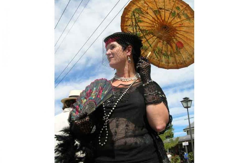 Antique attire . . . Mandy Mayhem, of Waitati, beats the heat with a suitably-styled parasol and...