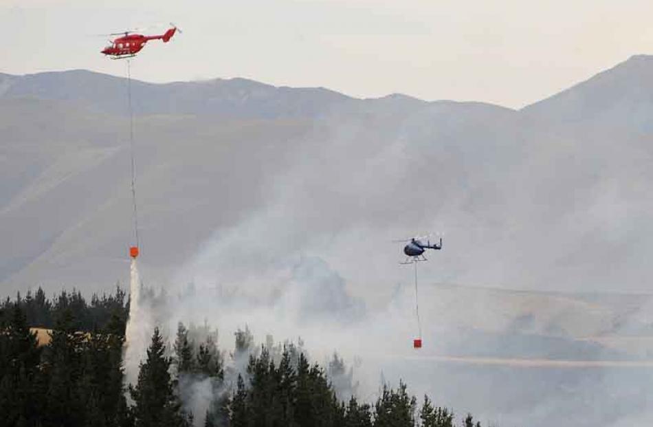 Helicopters are used to fight a forest fire west of Palmerston. Photo by Peter McIntosh.