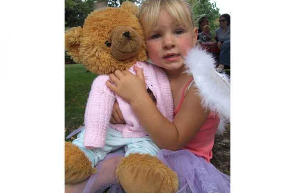 Brooke Warden (4), of Oamaru, cuddles Sunny during the teddy bears' picnic at the Oamaru Public...