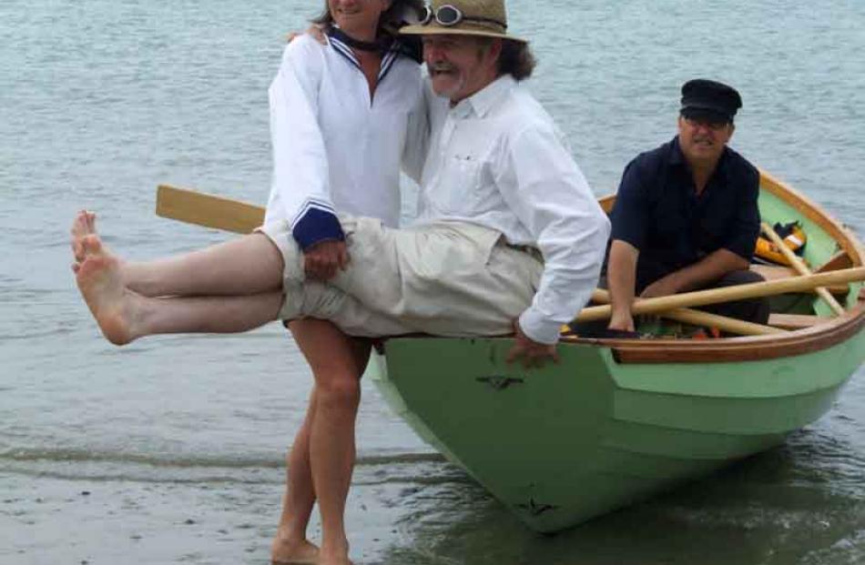 Kay Schrader and Iain Clark ham it up during the Oamaru harbour regatta, watched by Doug Carson....