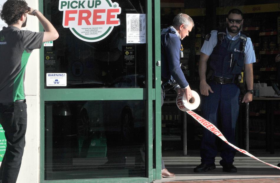 Police tape the front door of the supermarket after the stabbing attack today. Photo: Christine O'Connor