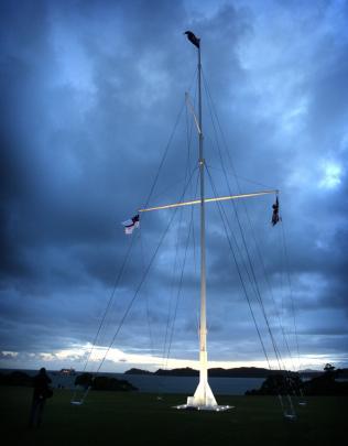 The flagstaff, at the Waitangi Treaty grounds, Bay of Islands, flies the New Zealand flag (top),...