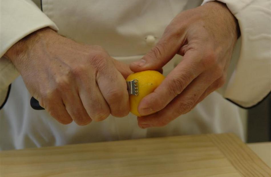 1. Use either a zester, which you pull against the lemon to shave off fine strips, or a grater.
