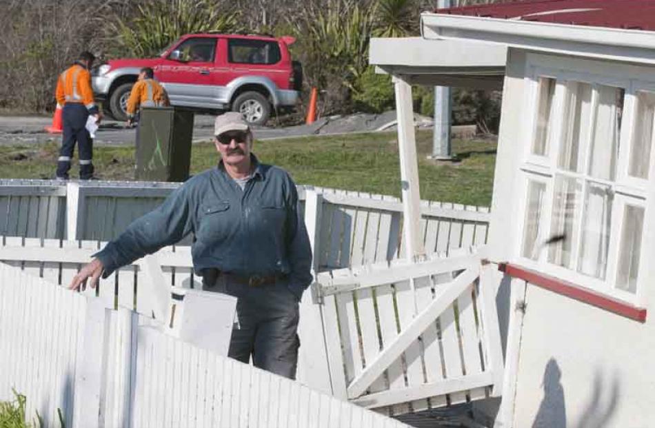 Builder Lindsay Wilson and the now condemned house he was restoring for the owner in Dunns Avenue...