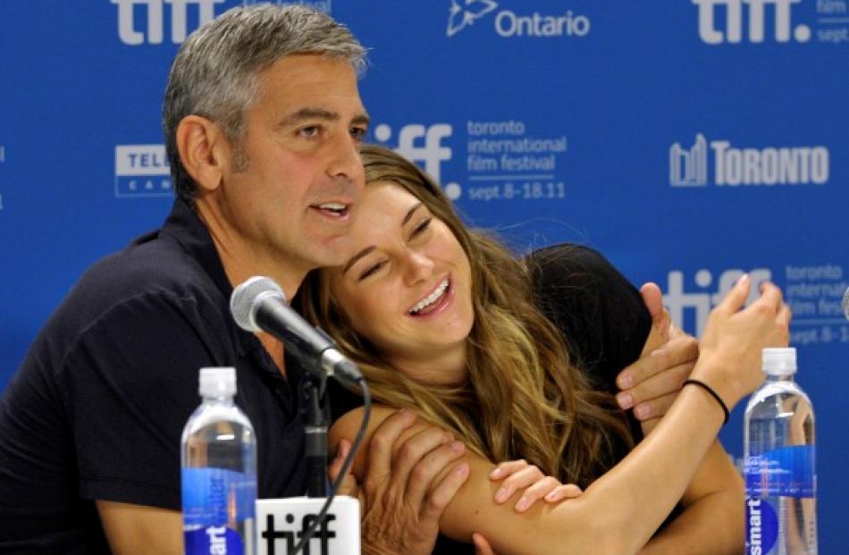 Actor George Clooney hugs actress Shailene Woodley at the news conference for the film 'The...