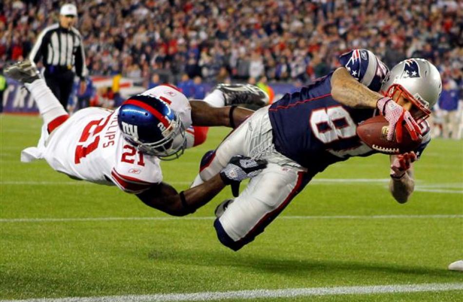 New England Patriots tight end Aaron Hernandez dives into the end zone for a touchdown through...