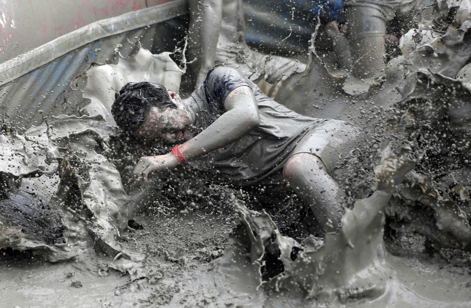 Tourists attend the Boryeong Mud Festival at Daecheon beach in Boryeong. Photos by Reuters