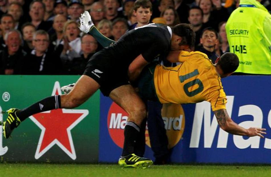 Richard Kahui dumps Quade Cooper on his back. REUTERS/Mike Hutchings