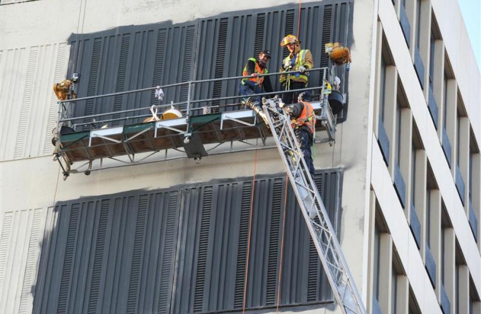 A Dunedin fireman rescues two painters trapped on a scaffold 27m up the side of Radio House in...