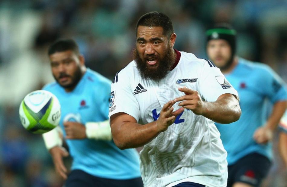 Charlie Faumuina of the Blues passes during the round seven Super Rugby match between the...
