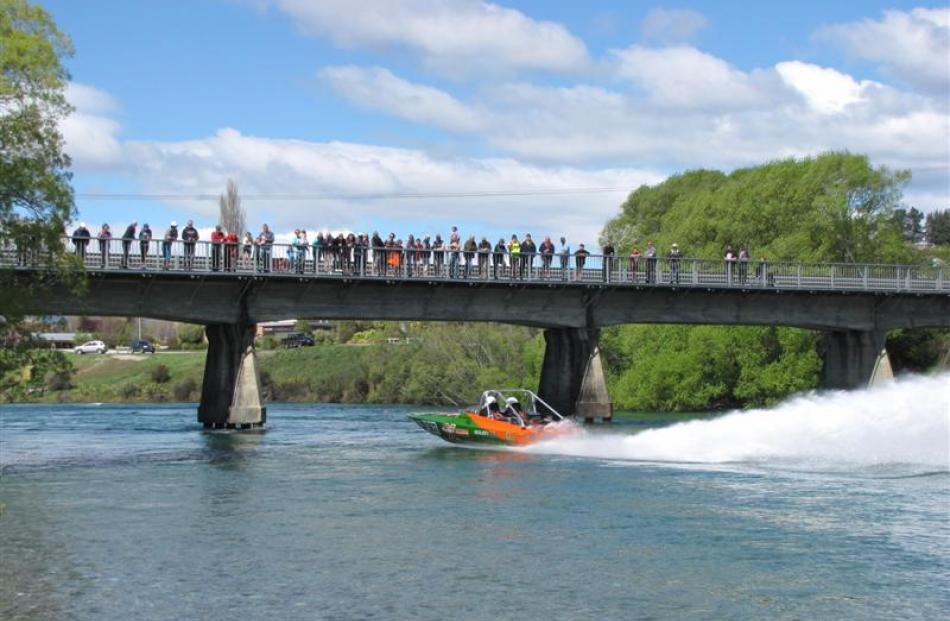 Crowds gathered on the Albert Town Bridge watch Otautau driver Roger Preston and navigator Damian...