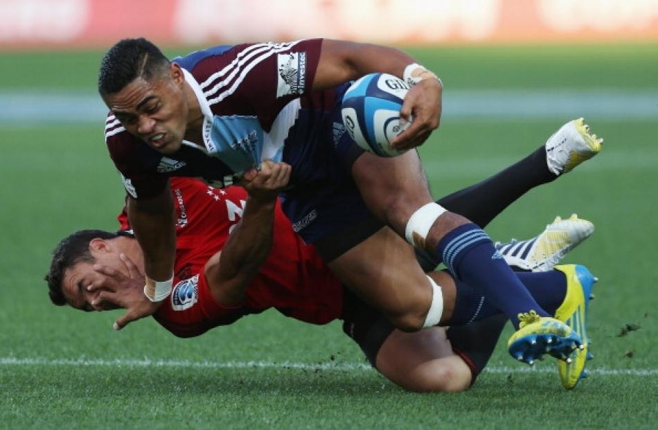 Francis Saili of the Blues fends off Daniel Carter of the Crusaders during the round 3 Super...