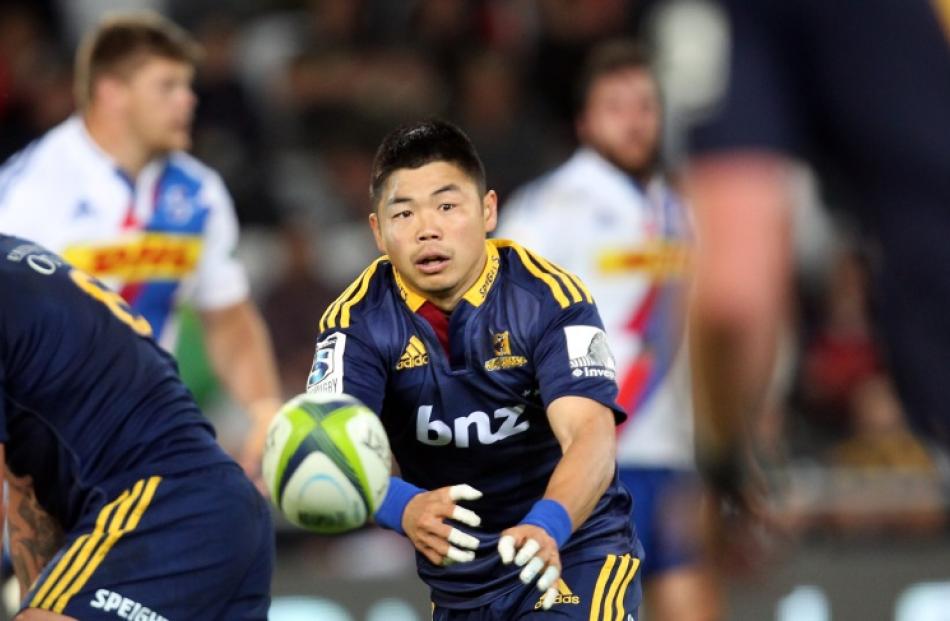 Fumiaki Tanaka of the Highlanders passes the ball during the round seven Super Rugby match...