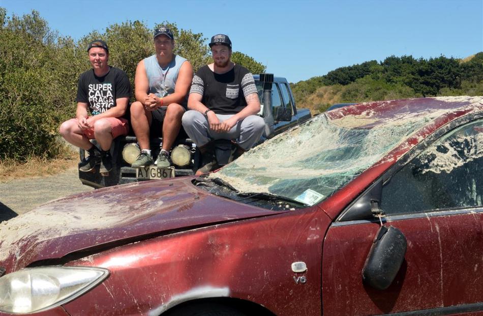 Inspecting the Toyota Camry they helped salvage from a Dunedin beach are (from left) Rhys...