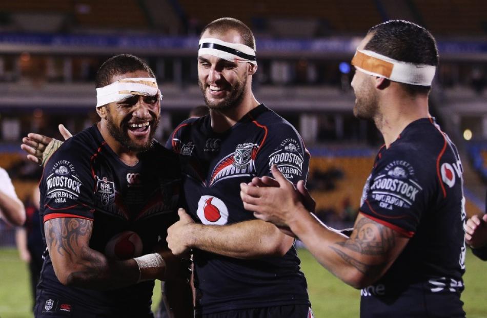 Manu Vatuvei of the Warriors is congratulated by Simon Mannering of the Warriors and Bodene...