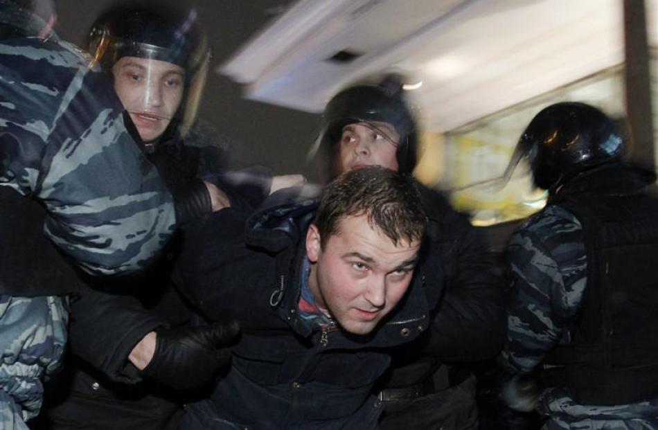 Russian police detain a participant during an opposition protest in central Moscow  on Monday....