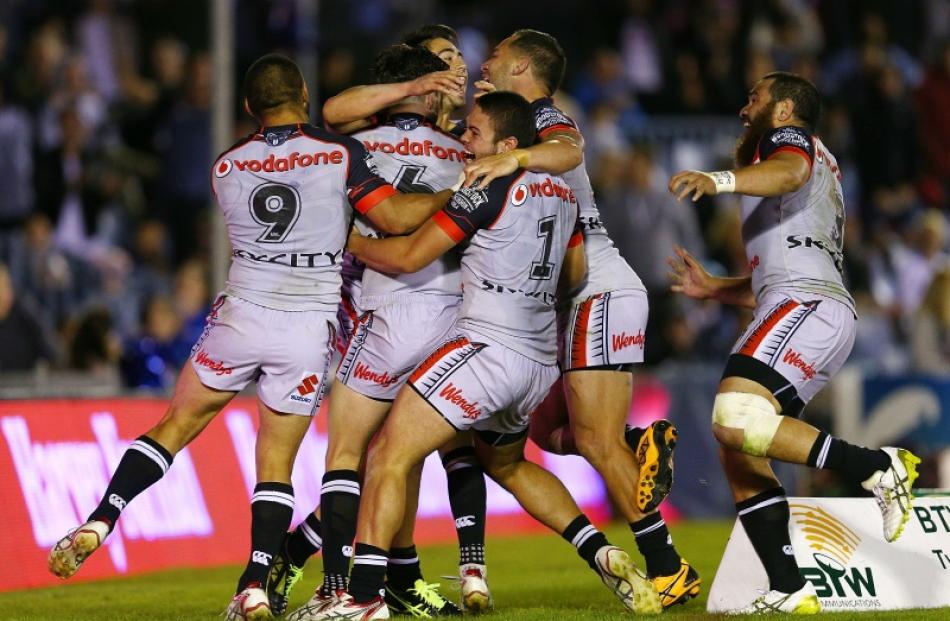 Shaun Johnson of the Warriors celebrates his winning try with team mates during the round nine...