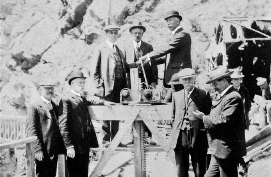 The Mayor of Dunedin, Mr John  Wilson, turns water into the new tunnel to feed the Waipori power...