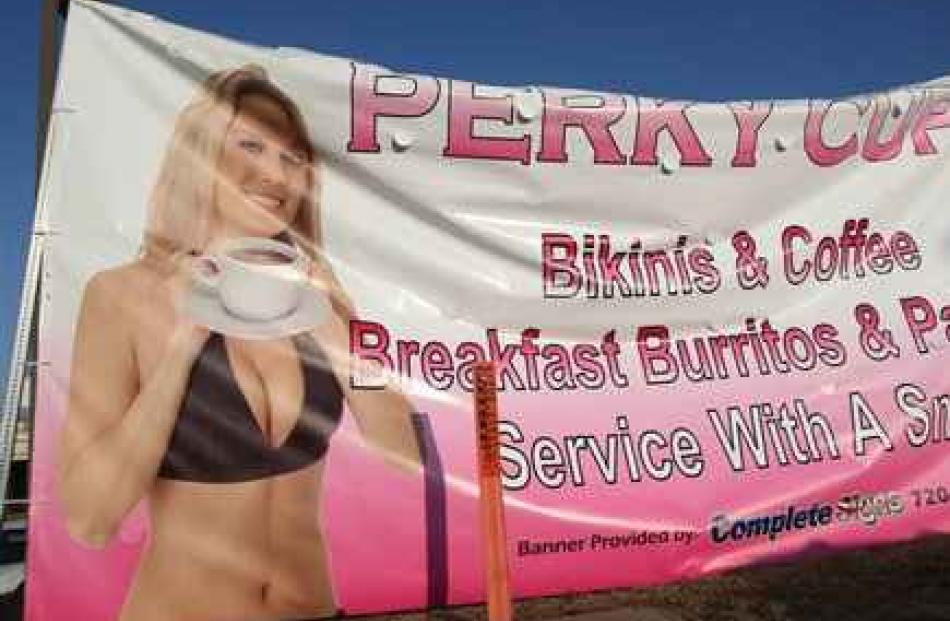 A banner is shown outside a suburban Denver coffee shop called Perky Cups. Officials say a bikini...