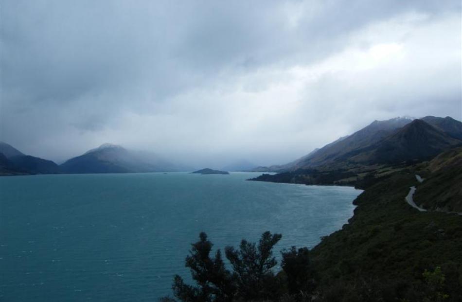A brooding Lake Wakatipu is flanked by snow-dusted mountains on the road to Glenorchy and Kinloch...