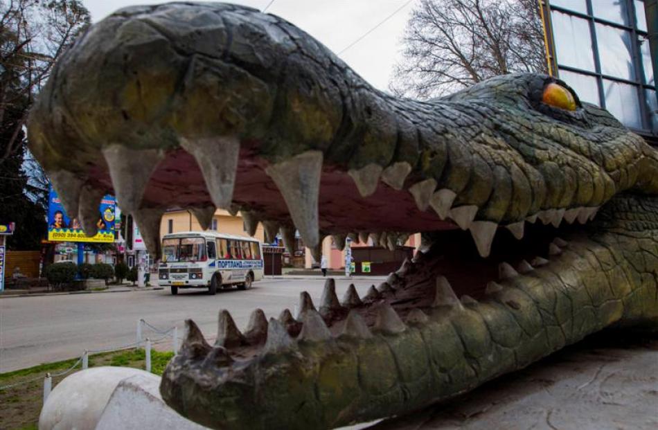 A bus drives past a tourist attraction in the Black Sea resort town of Alushta. Ukraine's Crimean...