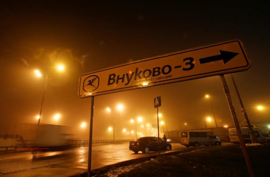 A car drives past a sign near Moscow's Vnukovo airport, where the chief executive of French oil...