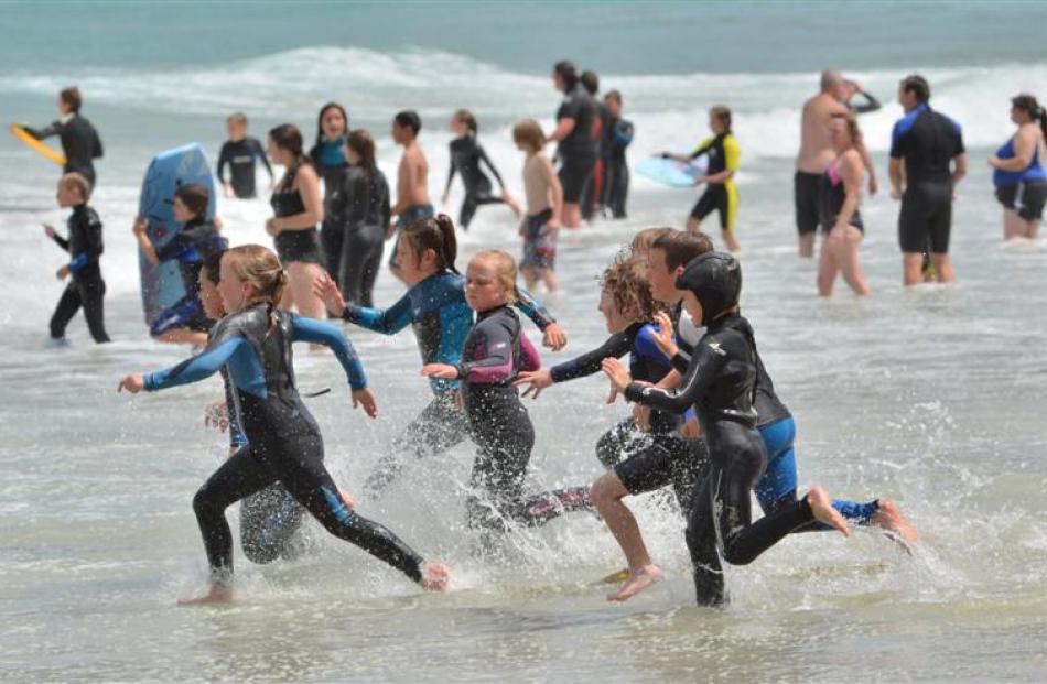 A class of ''Nippers'' from the St Clair Surf Life Saving Club join swimmers at St Clair Beach on...