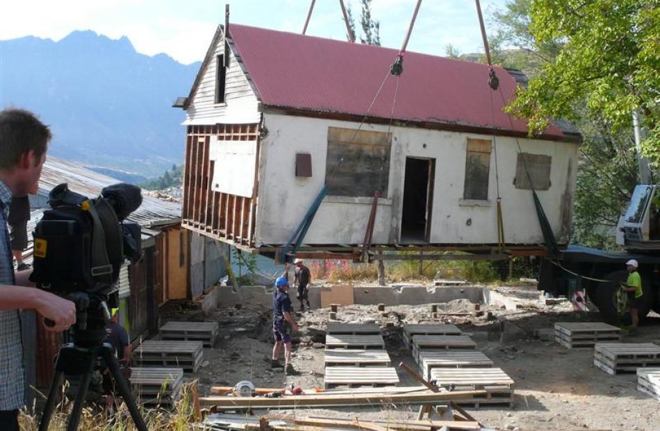 A crane hoists the historic New Zealand Railways ticket office off its piles   last week, for ...